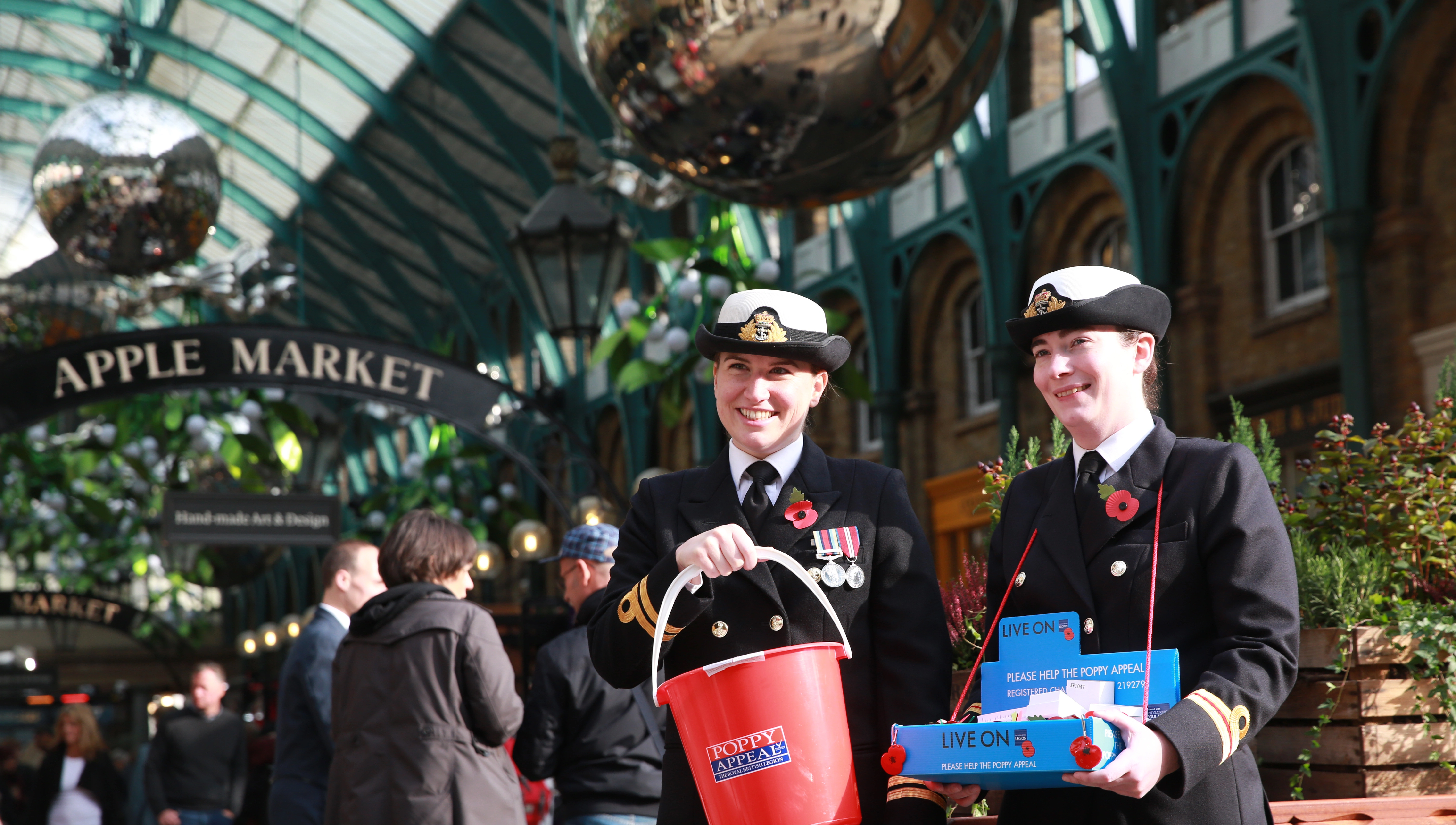 Royal British Legion Poppy Appeal collectors in a market