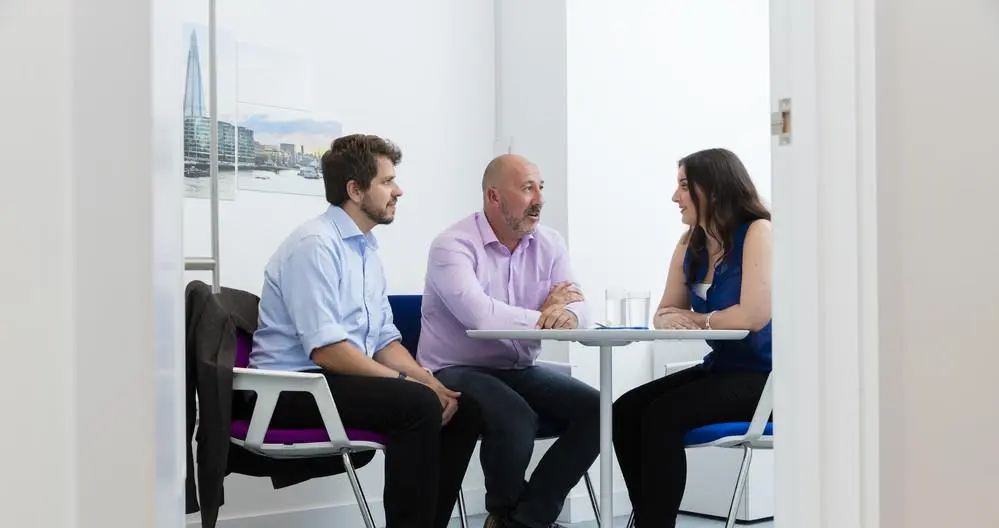 Three people in a meeting at The Royal British Legion