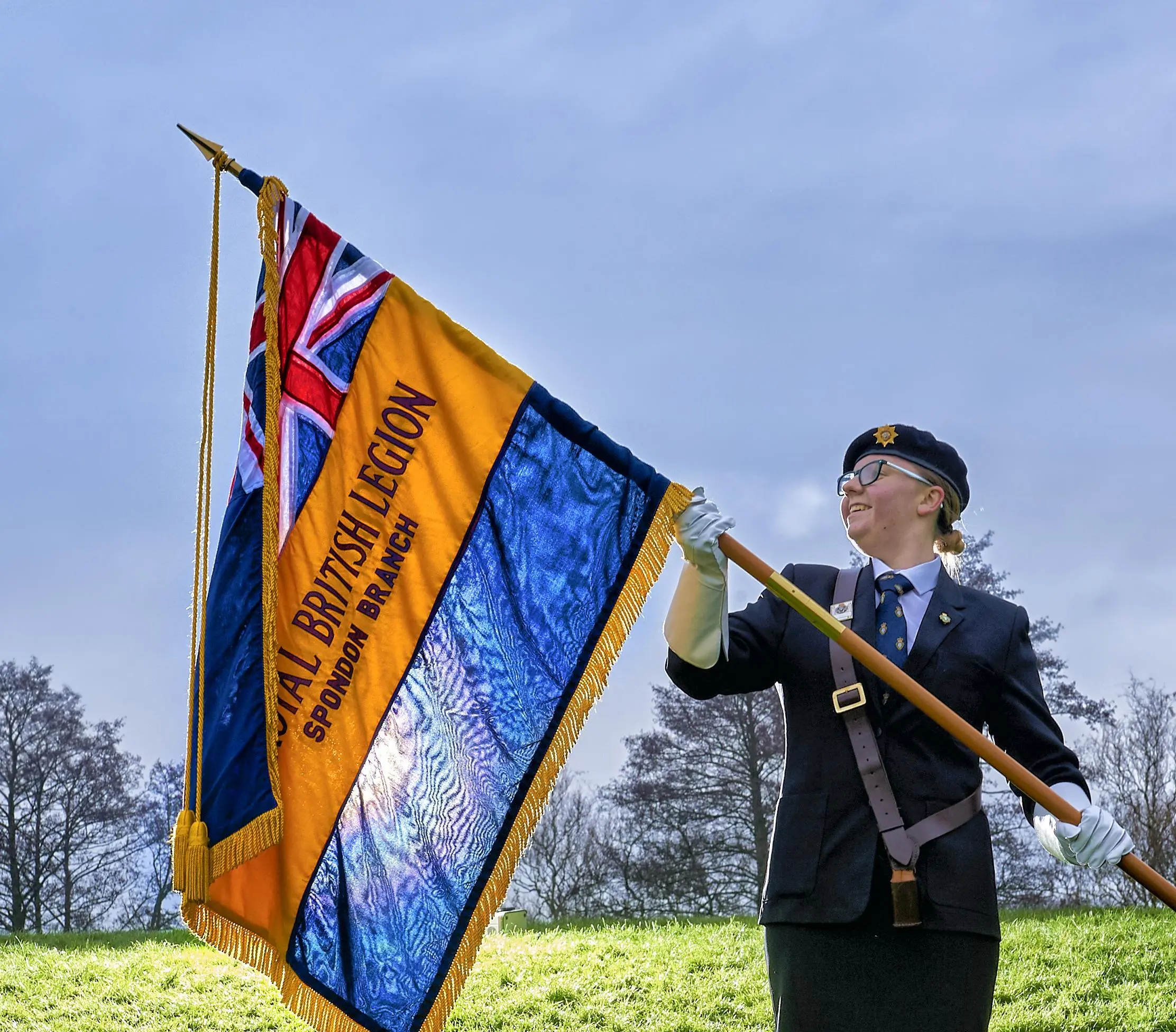 Youth member Maddie Hempell holding her branch Standard