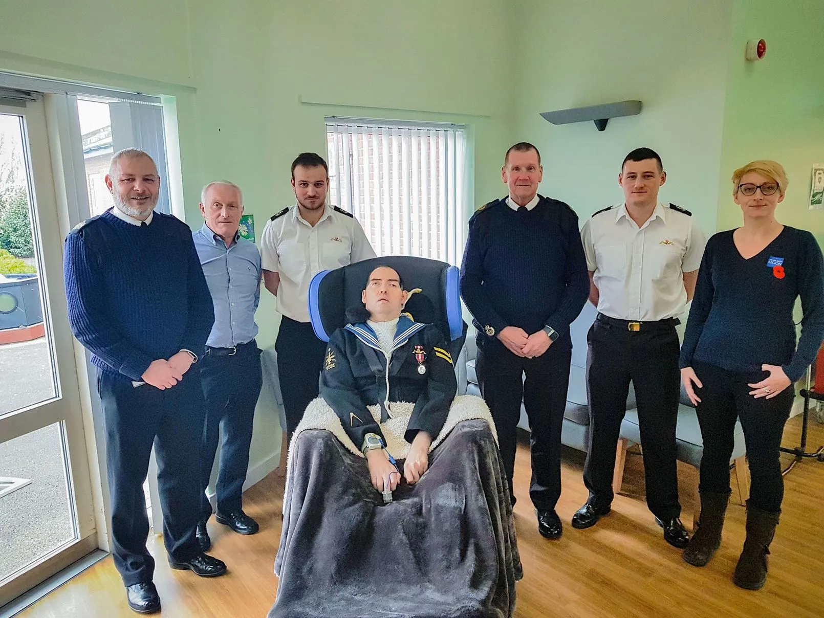 The Legion and Navy representatives present the Reynolds' with Paul's wheelchair 